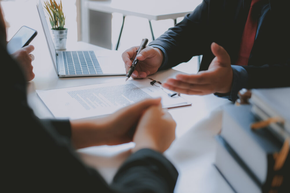 Lawyer Insurance Broker Consulting Giving Legal Advice To Couple